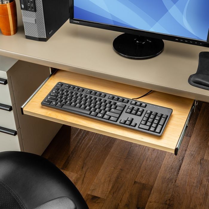 Side view of a desk showing keyboard tray height and monitor positioning
