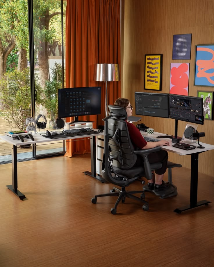 Overhead view of an organised workspace showing monitor, keyboard, and document zones